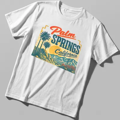 Vintage retro t-shirt featuring palm trees and mountains with sunset colors.