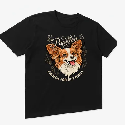 Illustration of a Papillon dog with 'Papillon French For Butterfly' text in warm colors — printed on a unisex t-shirt (angled view)