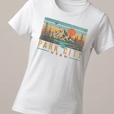 Retro distressed design featuring mountains and sunset with Park City Utah text — printed on a women's shirt
