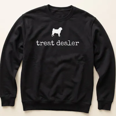 Simple silhouette of a pug with the text 'treat dealer' beneath in bold lettering — printed on a unisex sweatshirt