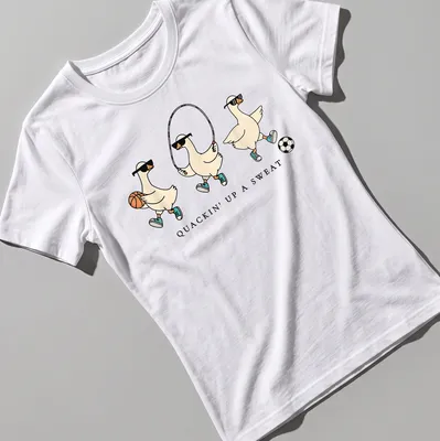 Cartoon goose with humorous text, Quackin' Up A Sweat, in vibrant colors — printed on a women's shirt
