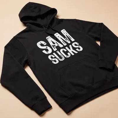 Bold typography shirt with the text 'SAM SUCKS' printed prominently. — printed on a unisex hoodie