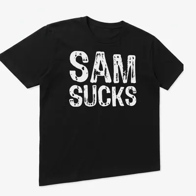 Bold typography shirt with the text 'SAM SUCKS' printed prominently. — printed on a unisex t-shirt (angled view)
