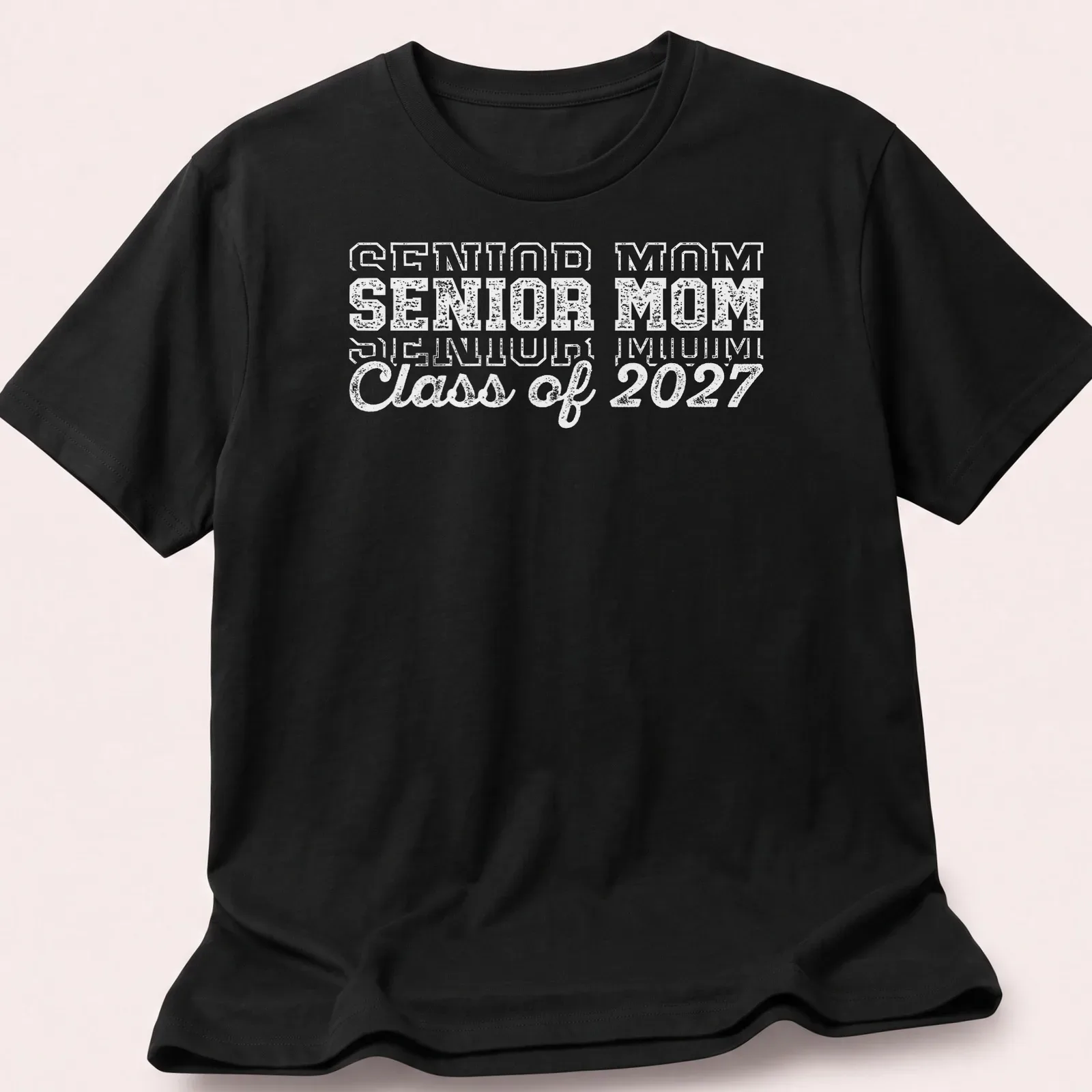 Bold text Senior Mom Class of 2027 graduation t-shirt in white — printed on a unisex t-shirt