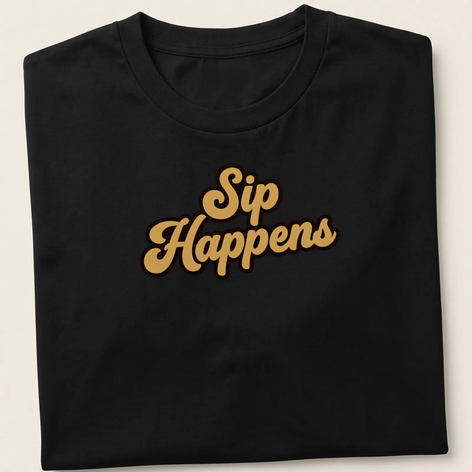 Bold script t-shirt with the humorous quote Sip Happens in gold on black background — printed on a unisex t-shirt
