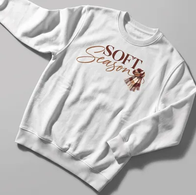 Autumn-themed t-shirt featuring a cozy scarf and the text 'Soft Season' in modern script. — printed on a unisex sweatshirt