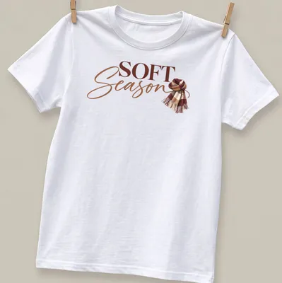 Autumn-themed t-shirt featuring a cozy scarf and the text 'Soft Season' in modern script.