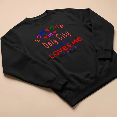 Colorful text design with hearts stating 'Someone In Daly City California LOVES me' — printed on a unisex sweatshirt