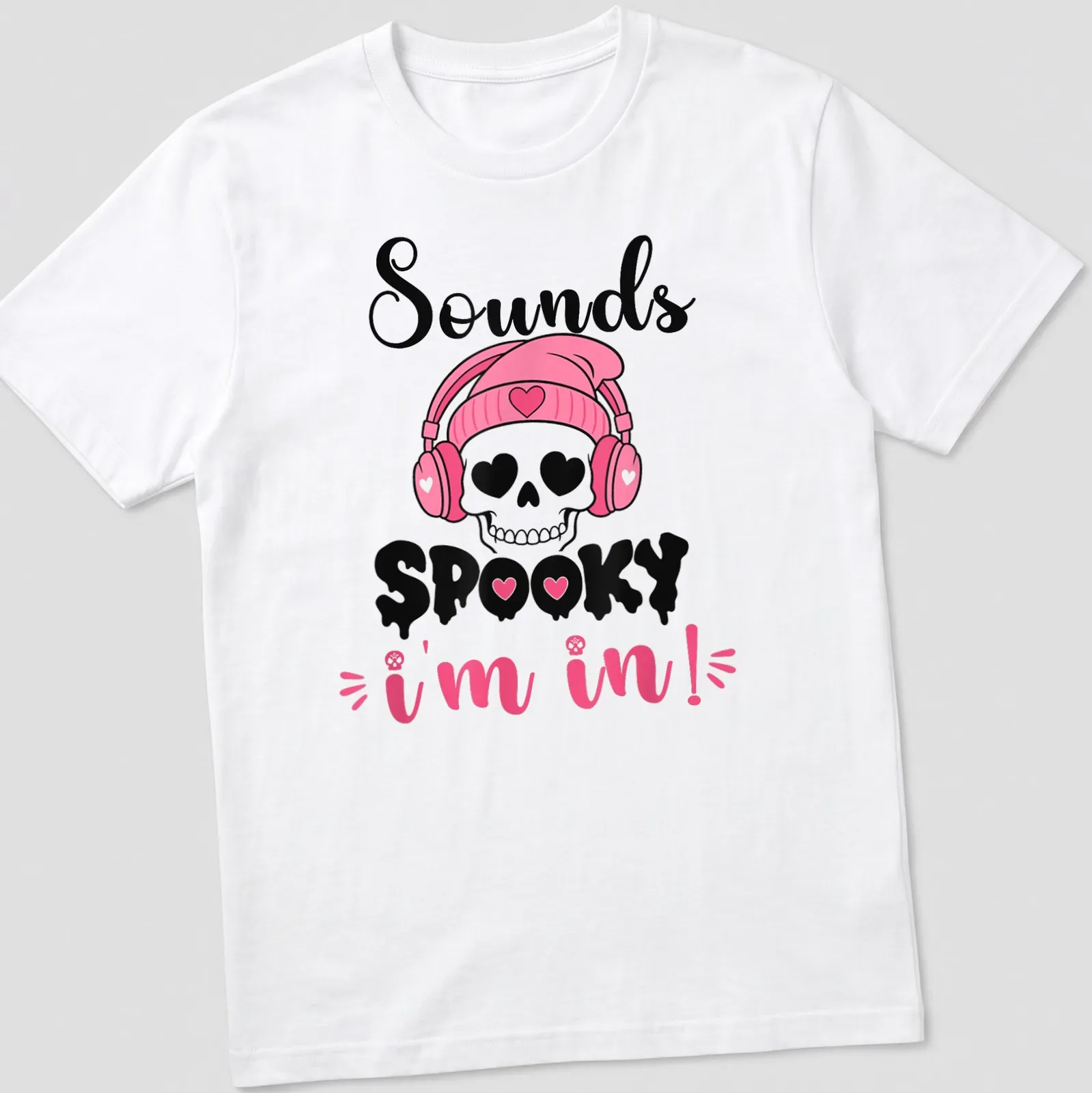 Cartoon skull with headphones and text 'Sounds Spooky I'm in!' in pink, black, and white — printed on a unisex t-shirt