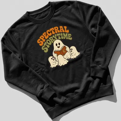 Whimsical retro design of ghosts reading a book with Spectral Storytime text — printed on a unisex sweatshirt