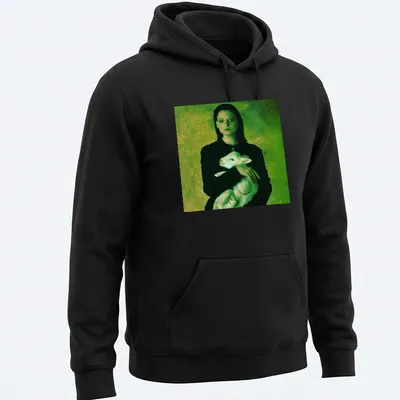 Vintage style t-shirt of a woman holding a lamb in green, black, and white — printed on a unisex hoodie