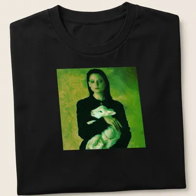 Vintage style t-shirt of a woman holding a lamb in green, black, and white