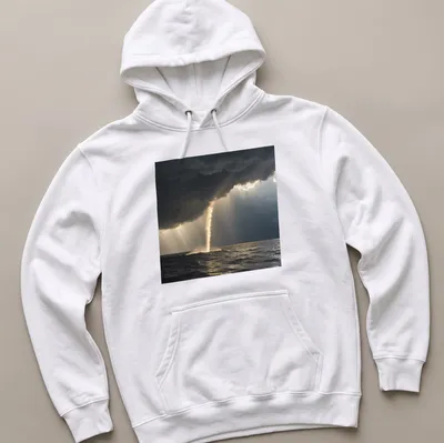Dramatic photography of a golden waterspout against dark gray and blue skies — printed on a unisex hoodie