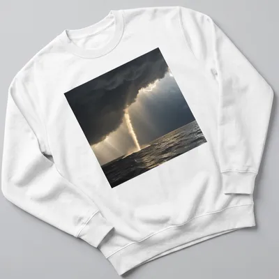 Dramatic photography of a golden waterspout against dark gray and blue skies — printed on a unisex sweatshirt