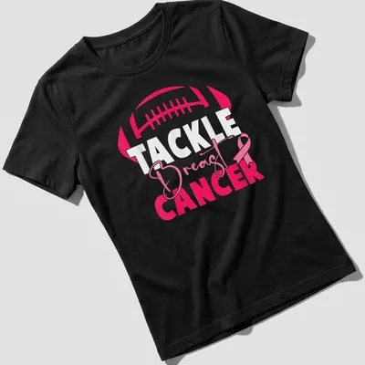 Bold football and pink ribbon design promoting breast cancer awareness — printed on a women's shirt