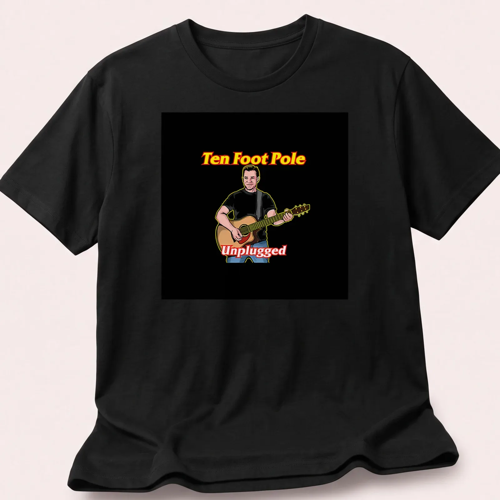 Cartoon illustration of a musician playing guitar with text Ten Foot Pole Unplugged — printed on a unisex t-shirt
