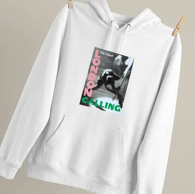 Vintage concert poster style t-shirt featuring The Clash guitarist in pink, green, black and white — printed on a unisex hoodie