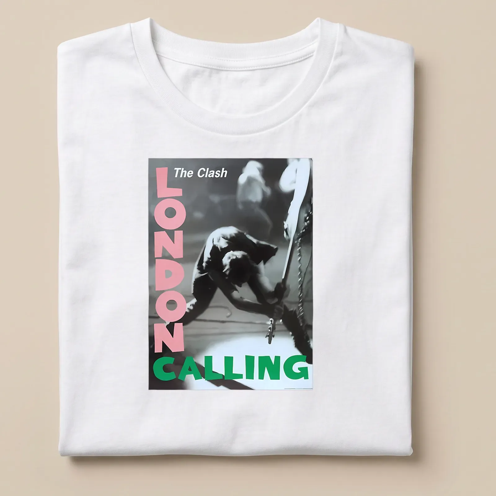Vintage concert poster style t-shirt featuring The Clash guitarist in pink, green, black and white — printed on a unisex t-shirt