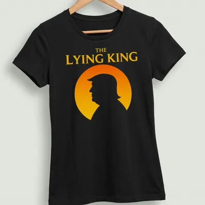 Minimalist silhouette of a man with text 'THE LYING KING' in orange and yellow — printed on a women's shirt