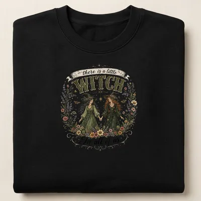 Illustrative floral design with two witches and whimsical text about magic. — printed on a unisex sweatshirt