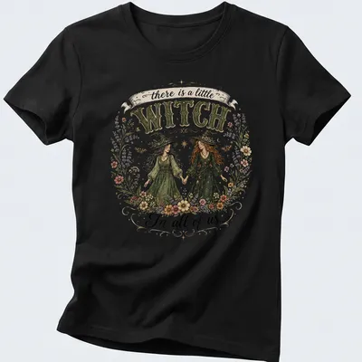 Illustrative floral design with two witches and whimsical text about magic. — printed on a women's shirt
