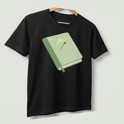 Illustration of a book with a crown and spoon in green, yellow, and brown — printed on a unisex t-shirt (angled view)