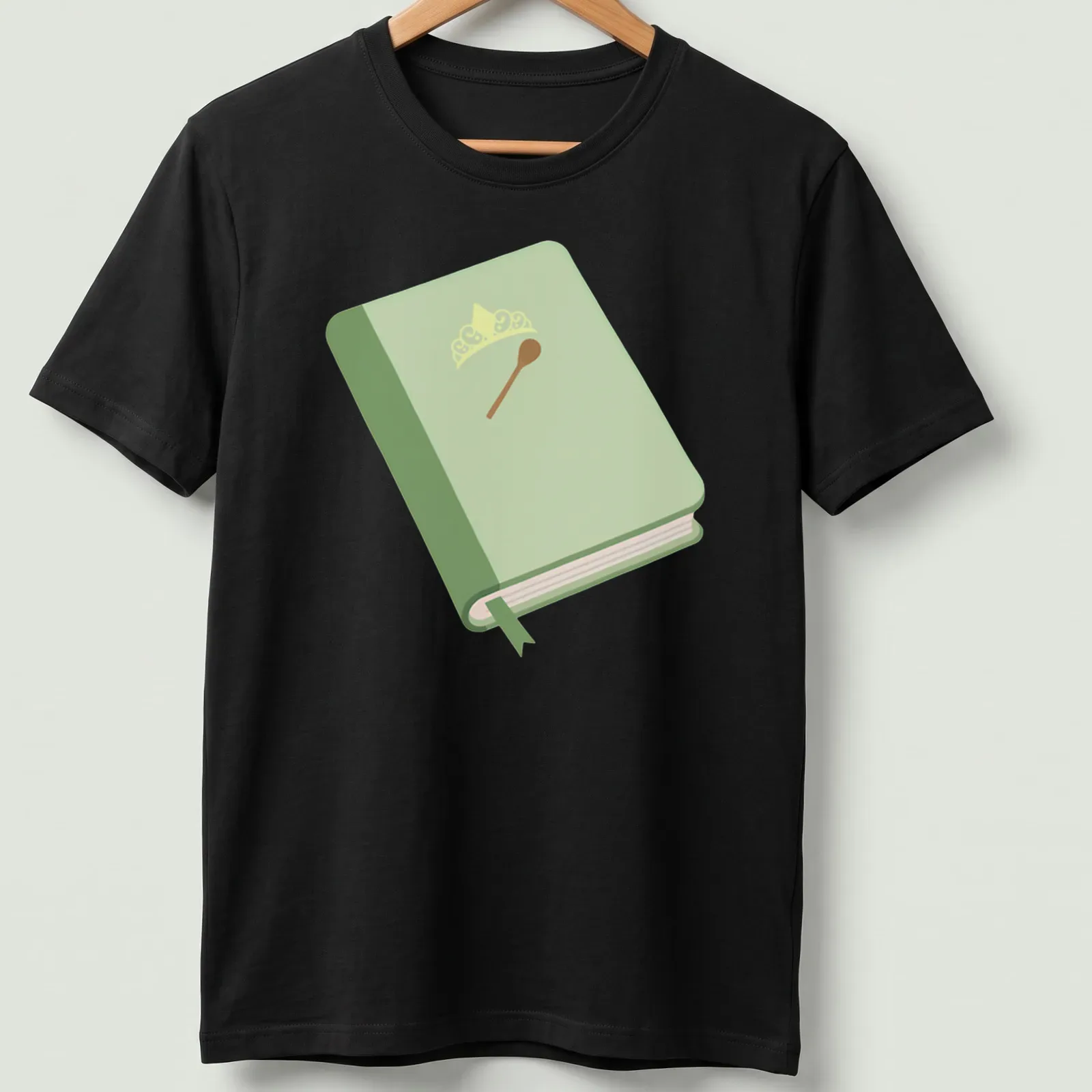 Illustration of a book with a crown and spoon in green, yellow, and brown — printed on a unisex t-shirt