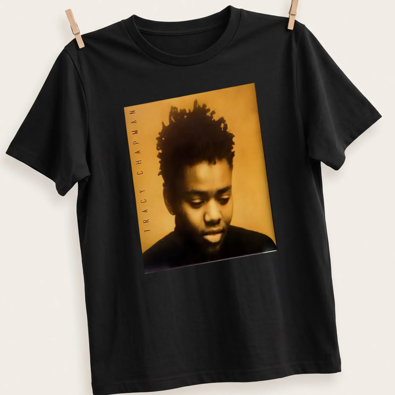 Photographic portrait of Tracy Chapman with her name beneath in bold lettering — printed on a unisex t-shirt