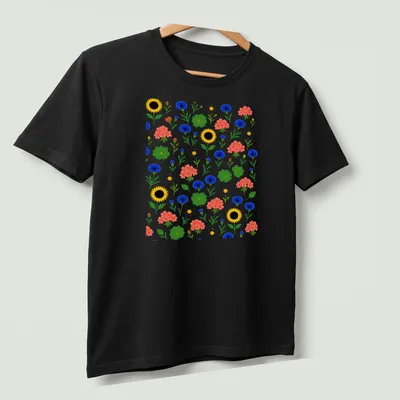 Colorful floral pattern featuring sunflowers and cornflowers in vibrant colors — printed on a unisex t-shirt (angled view)