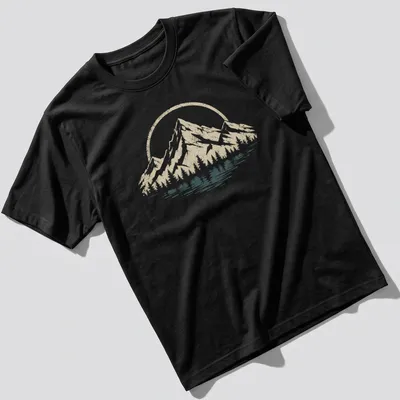 Retro distressed t-shirt featuring mountains and trees in beige, white, and dark teal