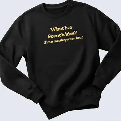 Text print reading What is a French kiss? I’m a tactile person btw in yellow and white — printed on a unisex sweatshirt