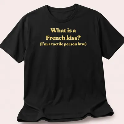 Text print reading What is a French kiss? I’m a tactile person btw in yellow and white — printed on a unisex t-shirt