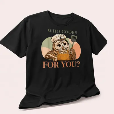 Cute owl chef stirring a pot with the text 'Who Cooks For You?' — printed on a unisex t-shirt (angled view)