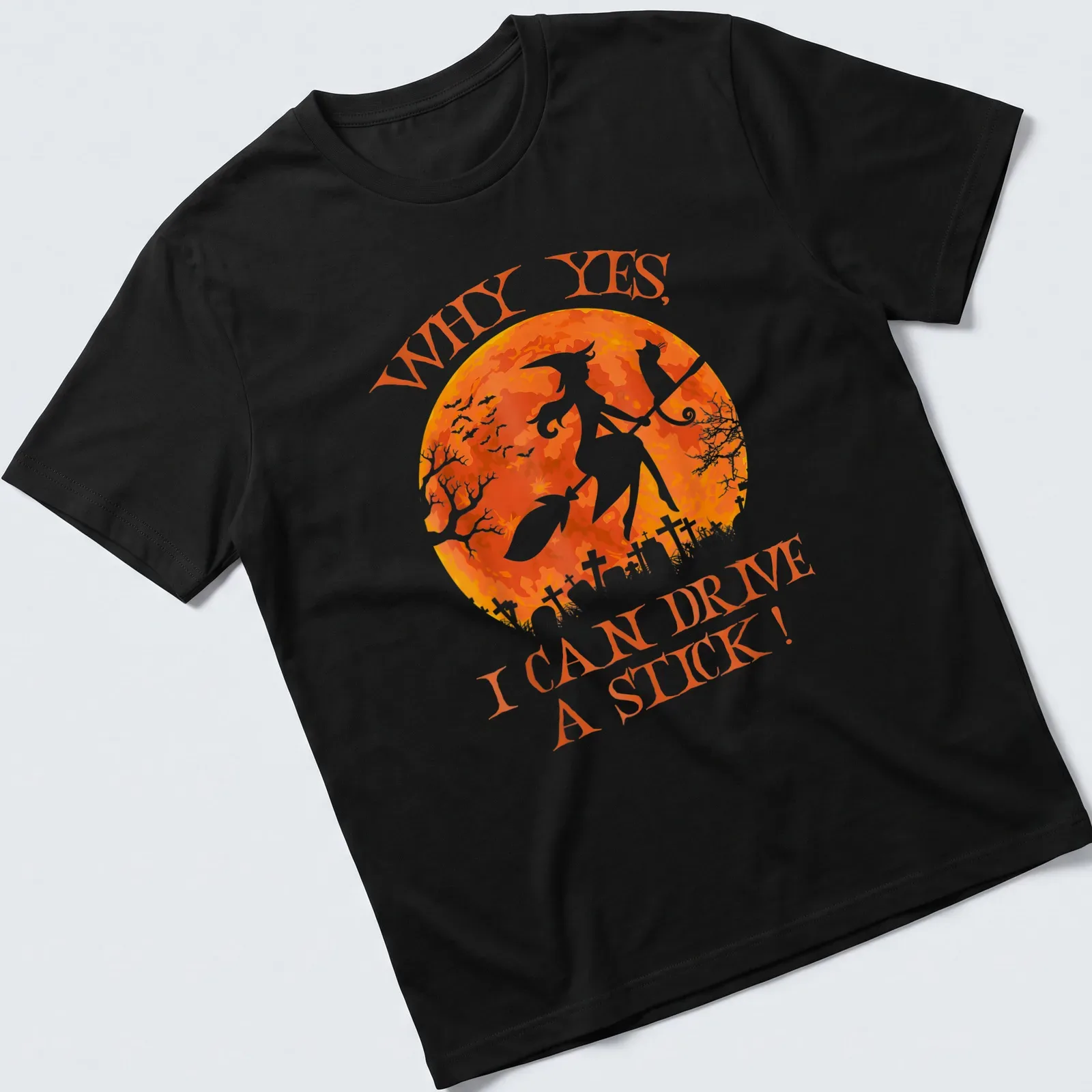 Whimsical watercolor print of a witch on a broomstick with a cat, featuring text about driving a stick. — printed on a unisex t-shirt