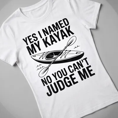 Bold graphic t-shirt featuring kayak and text about naming it — printed on a women's shirt