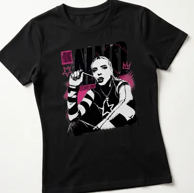 Cartoon baby character with the phrase 'Its Baby Nino' in a playful design. — printed on a women's shirt